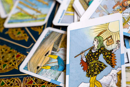 Assorted tarot cards scattered on a table, seamless pattern