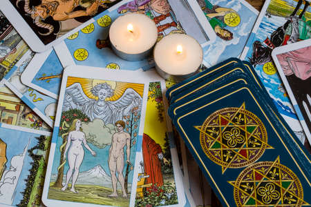 Assorted tarot cards scattered on a table, seamless pattern