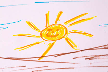 Drawing of sun on paper with crayon, closeupの写真素材