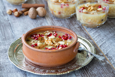 Oatmeal porridge with pomegranate and nuts in a bowlの写真素材