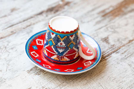 Cup of coffee with a pattern on a white wooden background.の写真素材