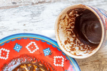 Traditional turkish coffee fortune, the shape of coffee grounds in the cup gives news from the future, looking at fortune telling in the saucerの写真素材
