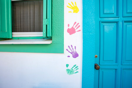 Colorful hand prints painted on the wall of a house in Portugalの写真素材