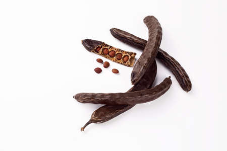 Carob pods isolated on white background. Carob pods with seeds.の写真素材