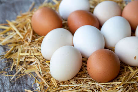 Eggs in a basket on a wooden background. Selective focusの写真素材