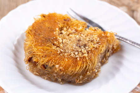 Traditional delicious Turkish desserts; Shredded dough baked in syrup topped with crushed nuts