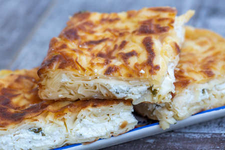 Su Boregi / Turkish Patty on wooden surface.