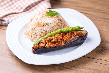 Stir-fried eggplant with chili and rice on wooden backgroundの写真素材