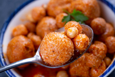 Meatballs in tomato sauce with chickpeas in a bowl.の写真素材