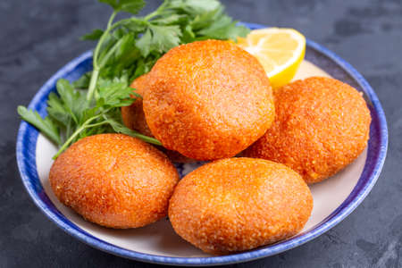 Fried arancini with lemon and parsley on a plateの写真素材
