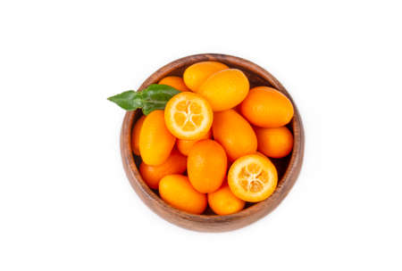 Top view of bunch of fresh kumquats in the organic food market. Some kumquats is cutted