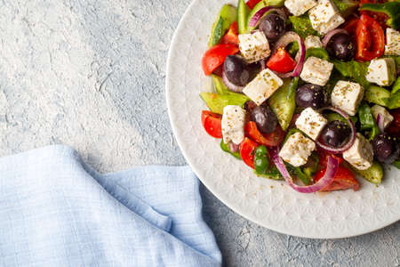Greek salad with fresh vegetables, feta cheese and kalamata olives. Healthy food.の写真素材