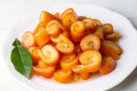 Plate with tasty caramelized carrots on wooden table, closeupの写真素材