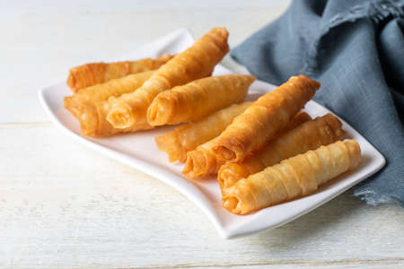 Crispy deep-fried dough sticks on white plate, closeupの写真素材