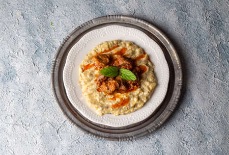 Risotto with meat and tomato sauce in a plate on a concrete backgroundの写真素材