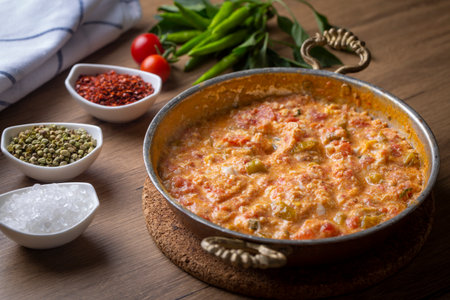 Famous Turkish menemen dinner on table, made by eggs, pepper and tomatoes.の写真素材