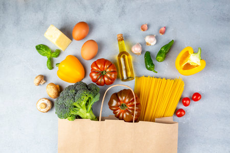 Photo of paper bag with vegetables, fruits and spaghettiの写真素材