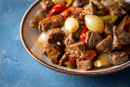 Beef Bourguignon with onions and peppers in a plate
