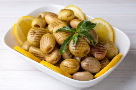 Grilled green olives. Tasty organic green olives in the plate.の写真素材