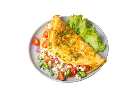 Homemade stuffed omelet on a plate. Egg omelet stuffed with fresh tomatoes, cheese and green parsley. Healthy vegetarian breakfast recipe.の写真素材