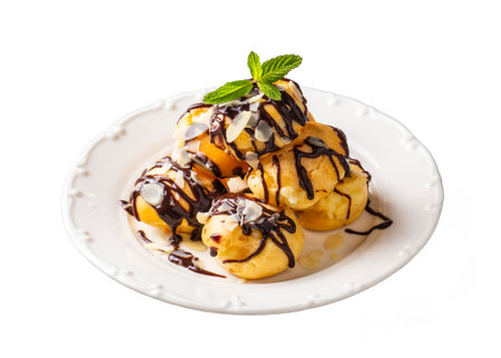 Delicious profiteroles with chocolate and white plate.の写真素材