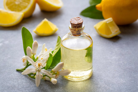 Fresh citrus essential oil. Lemon oil bottle with lemons fruitsの写真素材
