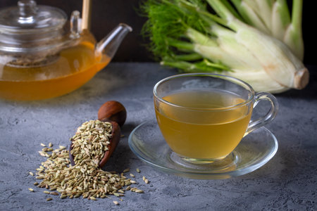 Aromatic fennel tea in cup and seedsの写真素材