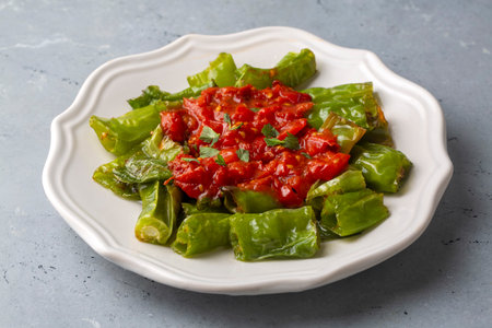 Fried peppers with tomato sauceの写真素材