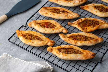Dishes from traditional Turkish cuisine; Mini pita with minced meat - Turkish name; Minced meat mini...