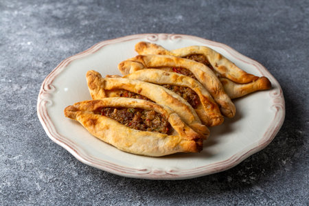 Dishes from traditional Turkish cuisine; Mini pita with minced meat - Turkish name; Minced meat mini...