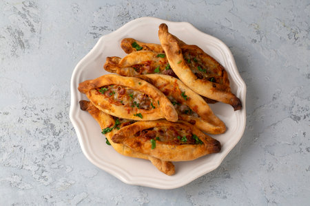 Dishes from traditional Turkish cuisine; Mini pita with minced meat - Turkish name; Minced meat mini...