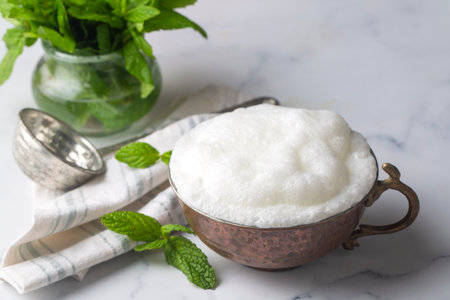 Glass cup of Turkish traditional drink ayran, kefir or buttermilk made from yogurt, healthy foodの写真素材