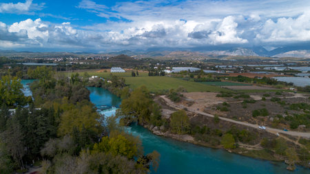 Manavgat Waterfall, Antalya. Stunning aerial view of Manavgat Waterfall with its vibrant turquoise waters and lush green vegetation. A breathtaking natural wonder from above.の写真素材