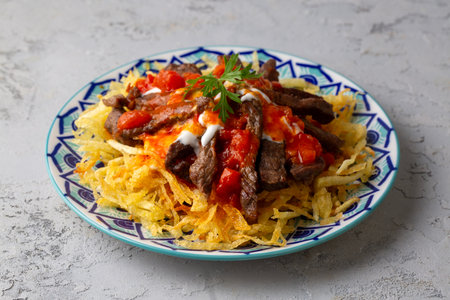 Turkish food; Cokertme Kebab - Beef meat kebab with yoghurt and french fries