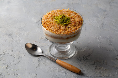 A traditional milk-based Ramadan dessert: fried kadayÄ±f (shredded phyllo dough) and custard with sliced ââpistachios. Kadafi Puddingの写真素材