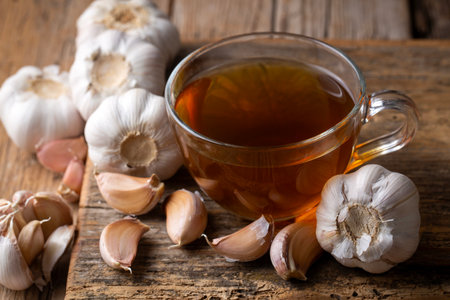 A cup of healthy garlic tea on the table.の写真素材