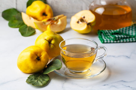 The cup of quince tea and fresh quince fruitの写真素材