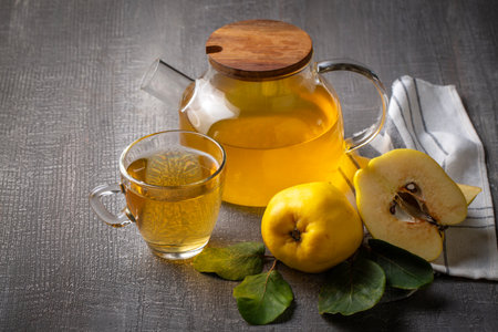 The cup of quince tea and fresh quince fruitの写真素材