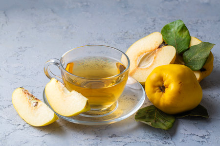 The cup of quince tea and fresh quince fruitの写真素材