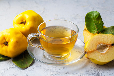 The cup of quince tea and fresh quince fruitの写真素材