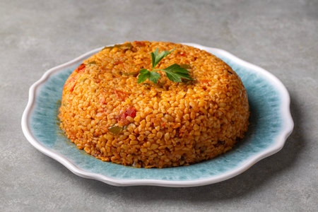 Traditional turkish bulgur pilaf with tomato sause in plate (Turkish name; meyhane pilaf)の写真素材