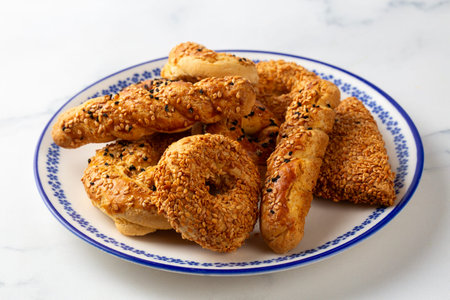 Traditional Turkish Savory Cookies with Sesame and Nigella Seeds on White Plate