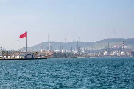 Industrial Coastal Horizon: Oil Storage Tanks and Wind Turbines at Aliaga Port Izmir