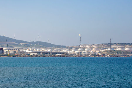 Industrial Coastal Horizon: Oil Storage Tanks and Wind Turbines at Aliaga Port Izmir