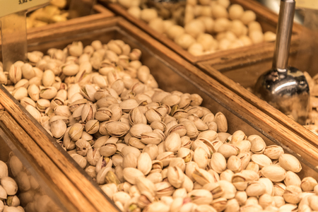 Pistachios in a wooden containerの写真素材