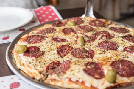 Argentinian Pizza with Salami and olives in El Calafate, Argentinaの写真素材