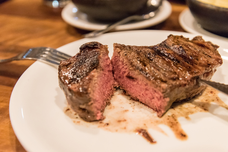 A juicy rib eye steak served in a restaurantの写真素材