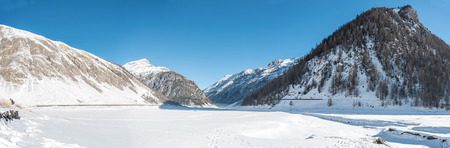 View over the frozen lake in Livigno, Italyの写真素材