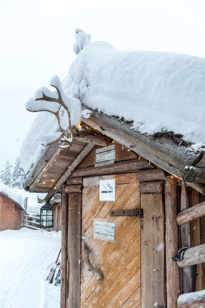 Wooden hut covered in snow near Rovaniemi in Lapland, Finlandの写真素材