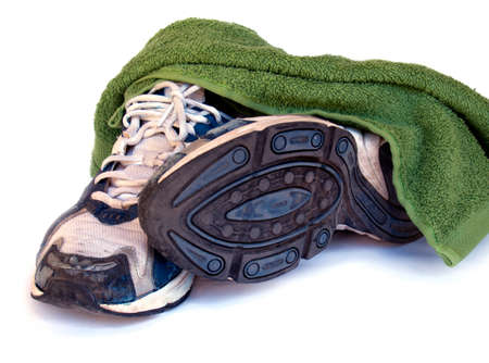 old sport running shoes isolated on white background with towelの写真素材